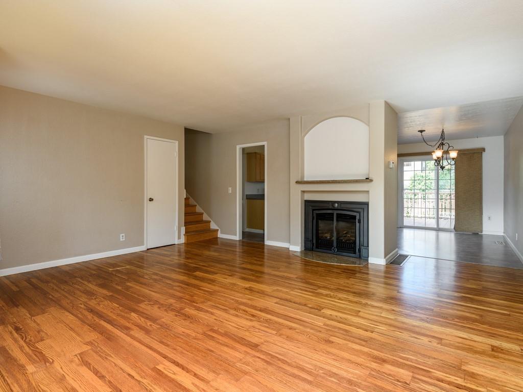 571 Lancaster Boulevard Moss Beach, CA 94038 - Photo 6 of 16 a view of empty room with wooden floor and fireplace