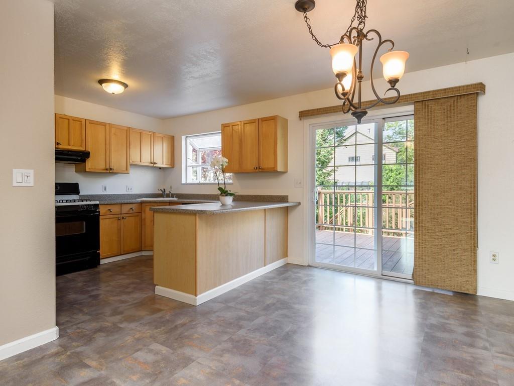 571 Lancaster Boulevard Moss Beach, CA 94038 - Photo 7 of 16 a kitchen with stainless steel appliances granite countertop a stove top oven a sink a counter space and cabinets