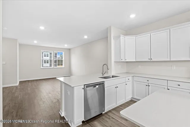 a kitchen with a sink cabinets and wooden floor