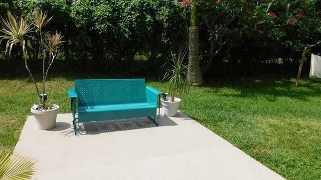 a green field with trees in the background