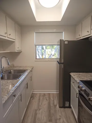 a kitchen with a sink stove and cabinets