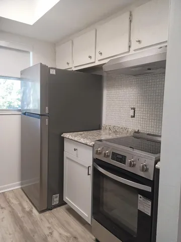a kitchen with a stove and a refrigerator