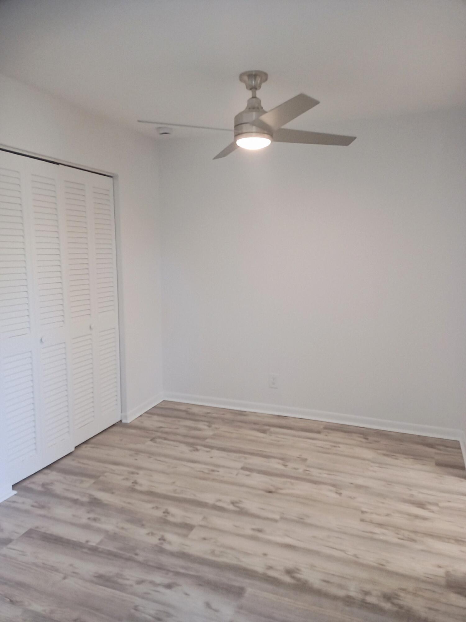 640 Southeast 2nd Avenue, Unit 202 Boynton Beach, FL 33435 - Photo 6 of 21 a view of an empty room with wooden floor