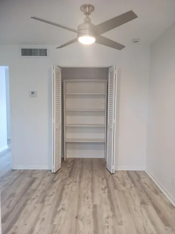 a view of a room with a ceiling fan