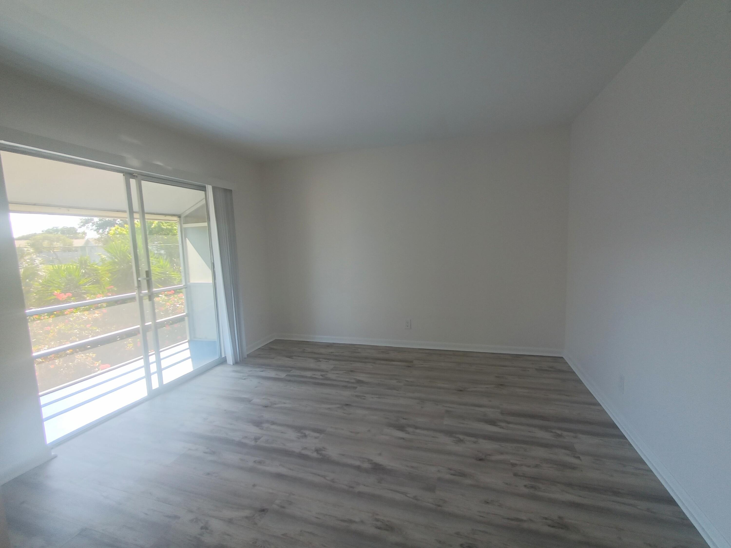 640 Southeast 2nd Avenue, Unit 202 Boynton Beach, FL 33435 - Photo 10 of 21 wooden floor in an empty room with a window