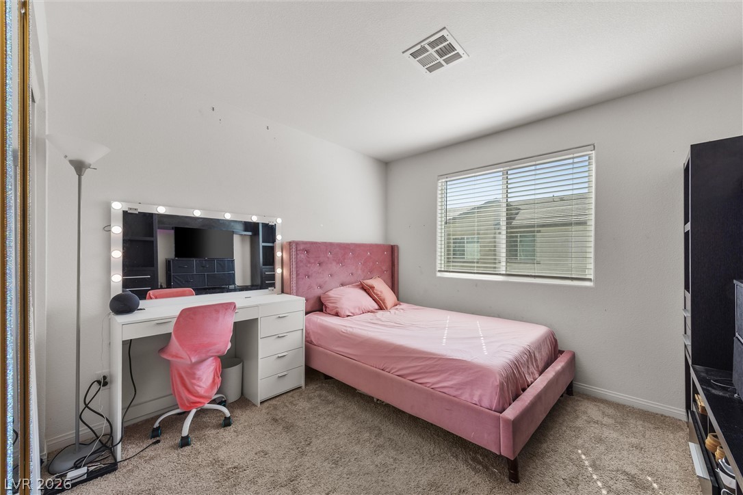 12240 Golden Wreath Road, Unit 2 Las Vegas, NV 89183 - Photo 8 of 29 A window bathes this carpeted bedroom in plenty of natural light.