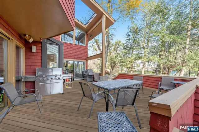 a front view of a house with swimming pool having outdoor seating