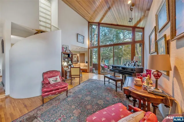 a reading room with furniture and a floor to ceiling window