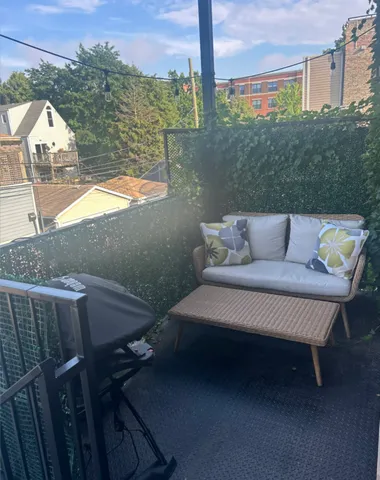 a view of a terrace with couches and wooden floor