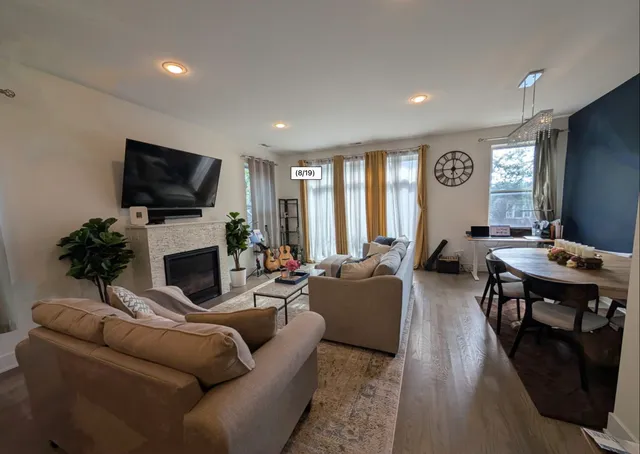 a living room with furniture a fireplace and a flat screen tv