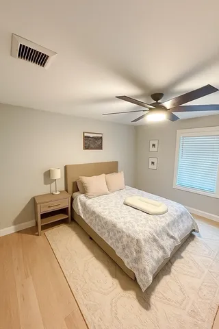 a spacious bedroom with a bed and a cabinets