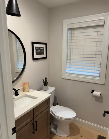 a bathroom with a toilet sink and mirror