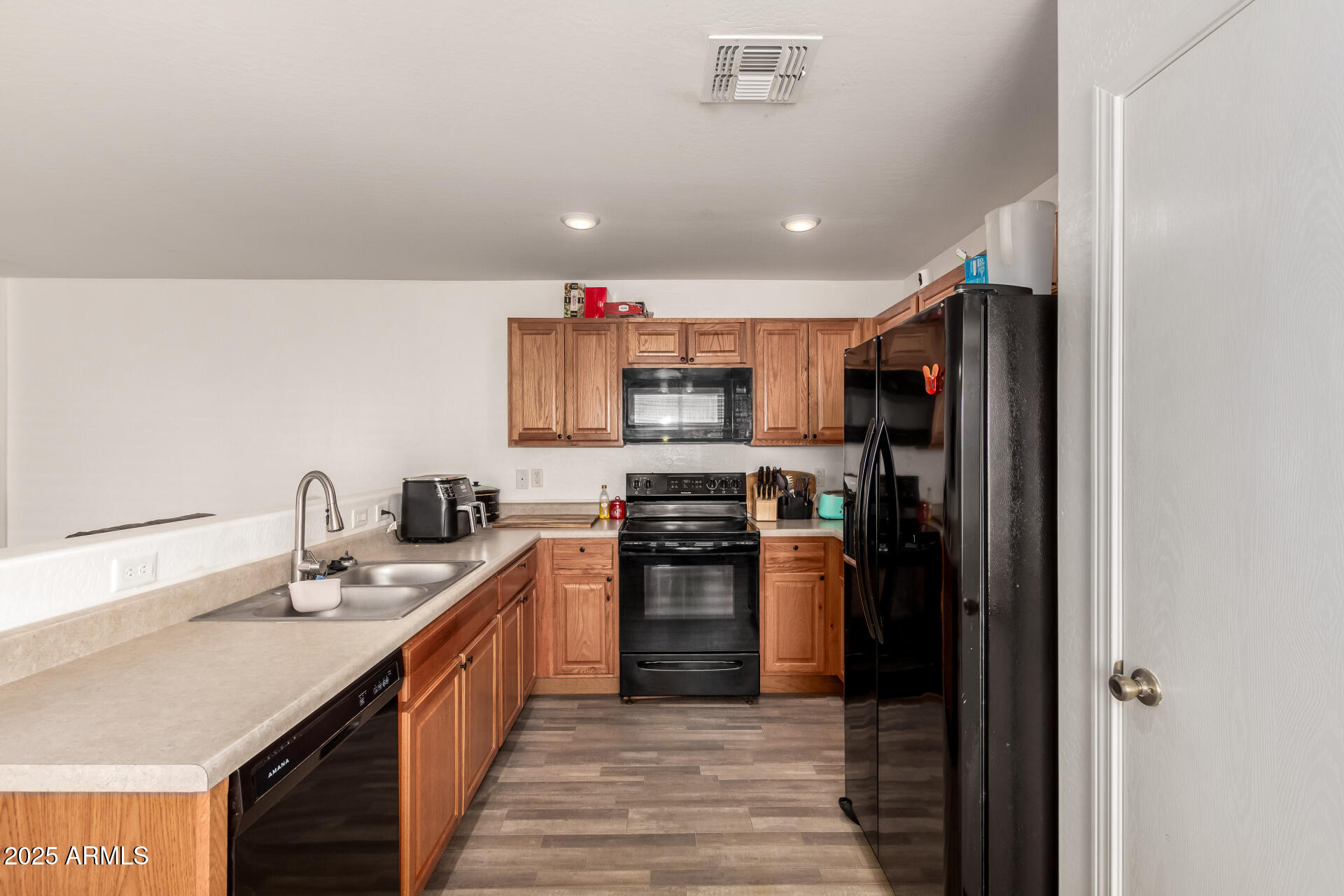 910 Prior Avenue Coolidge, AZ 85128 - Photo 6 of 22 a kitchen with kitchen island granite countertop a sink and a stove top oven