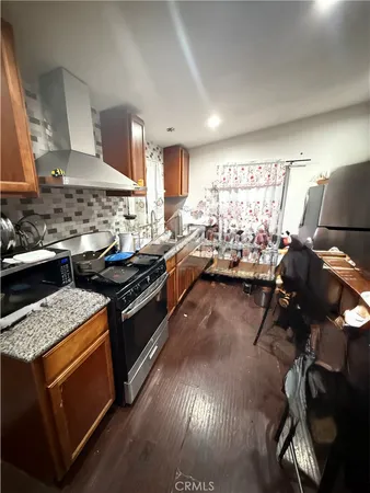 a kitchen with stainless steel appliances granite countertop a stove and a sink