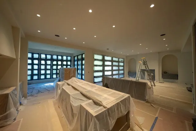 a large kitchen with a table and chairs