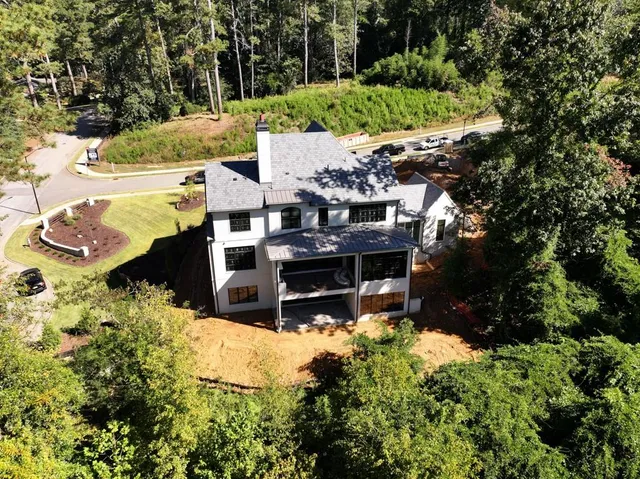 a view of a house with a yard and sitting area