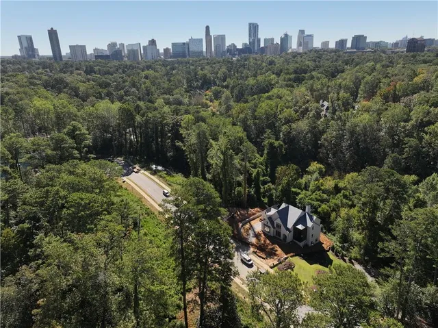 an aerial view of a house with a yard and a fountain