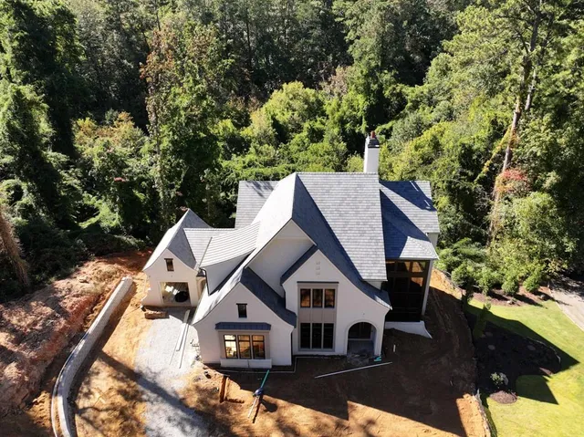 a view of a house with a yard covered in snow