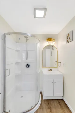 a bathroom with a sink a toilet and shower