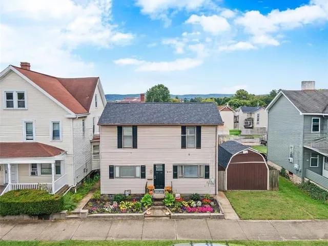 a front view of house with yard and green space