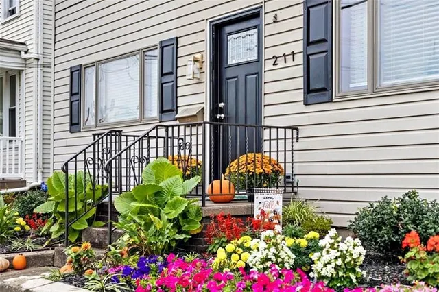 a view of a house with a flower garden
