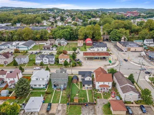 an aerial view of residential houses with outdoor space