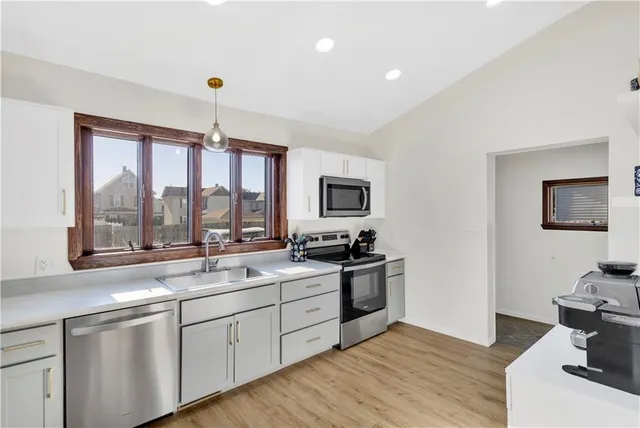 a kitchen with a sink stove and microwave