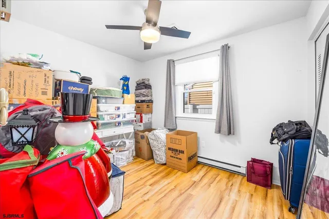 a bedroom with furniture and a flat screen tv