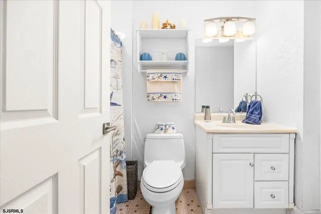 a bathroom with a toilet a sink and a mirror