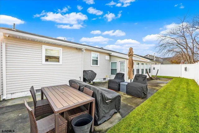 a view of a patio with table and chairs and potted plants