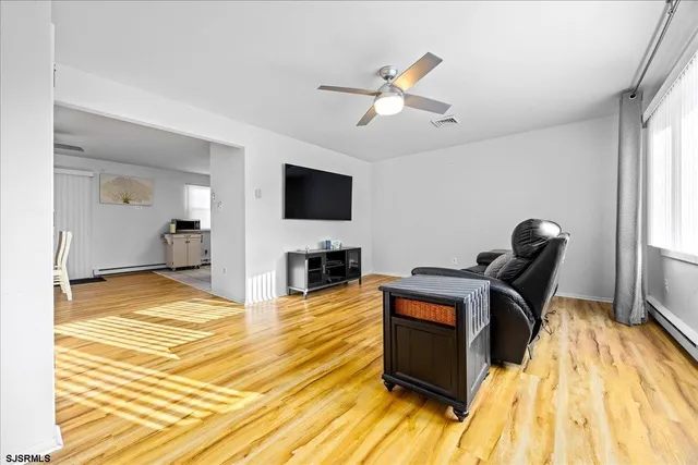 a view of a workspace with furniture and a flat screen tv