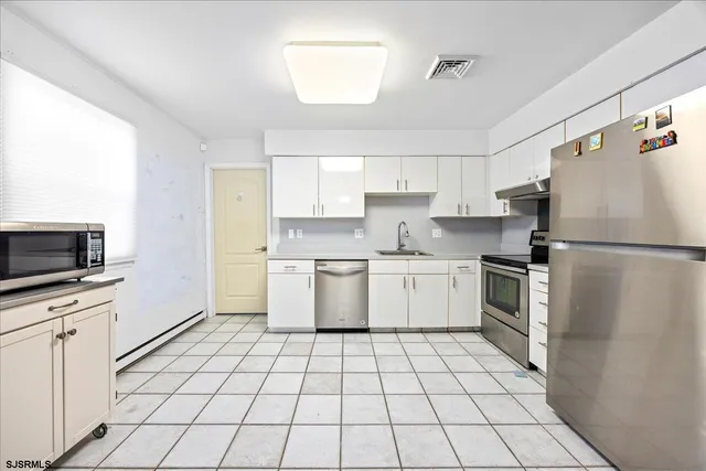 a kitchen with a stove sink and refrigerator