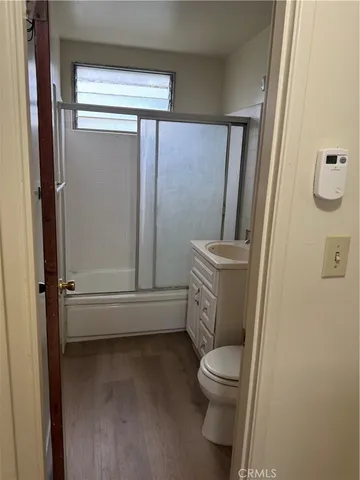 a bathroom with a granite countertop toilet and a shower