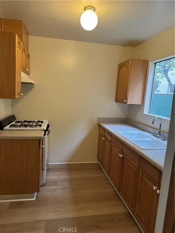 a kitchen with sink cabinets and stove