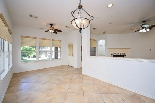 a view of empty room with a fireplace