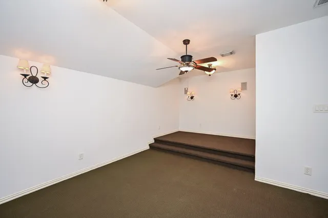 a view of room with a ceiling fan