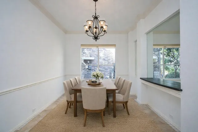 en empty room with windows and a ceiling fan