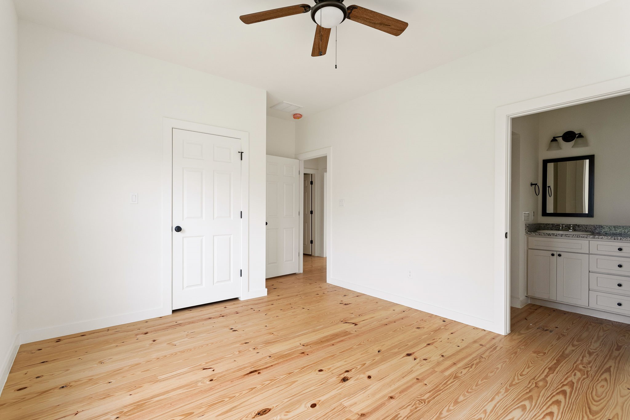 226 North Dixie Street Brenham, TX 77833 - Photo 12 of 22 a view of a room with a dresser and chandelier fan