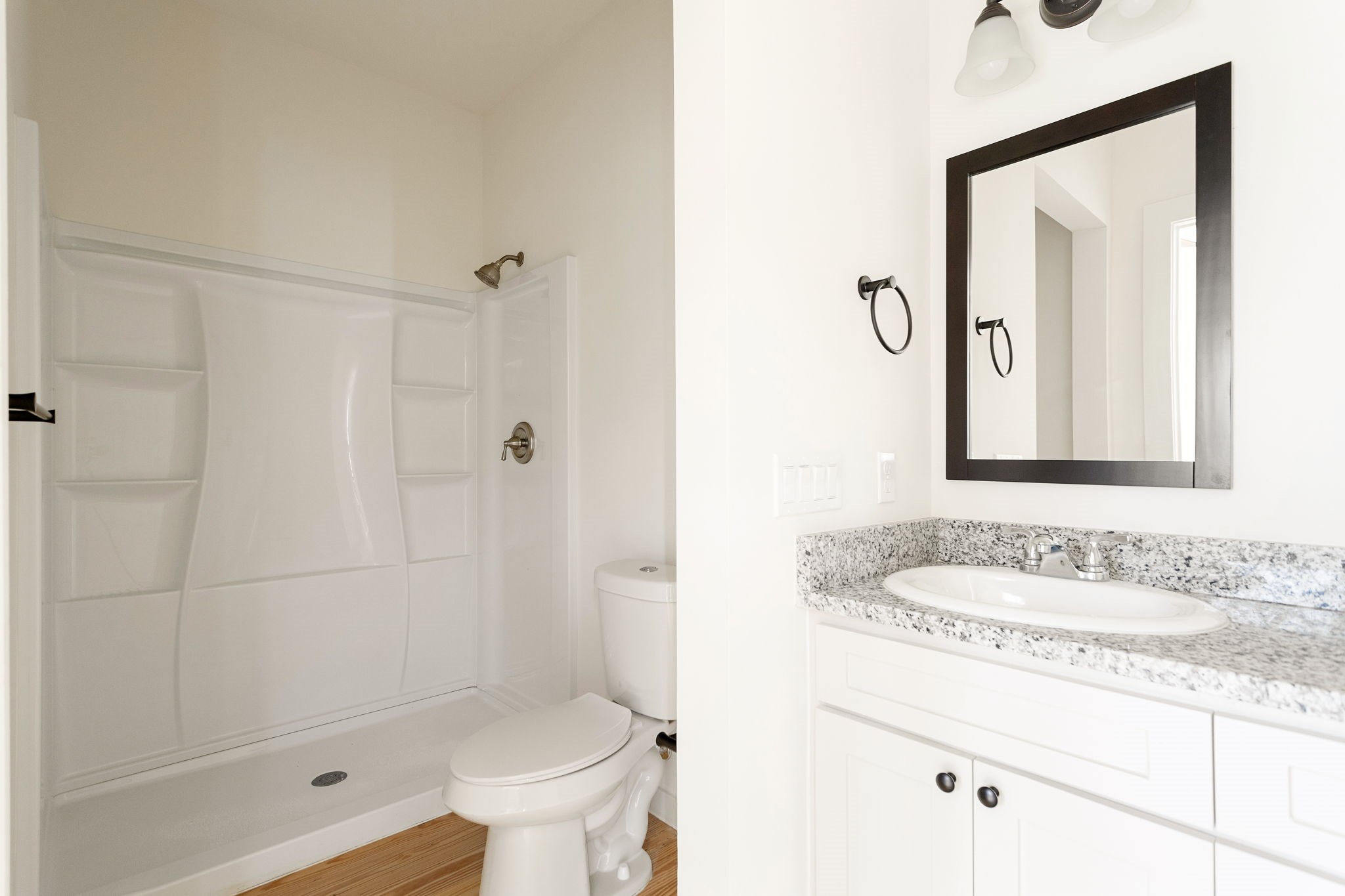 226 North Dixie Street Brenham, TX 77833 - Photo 15 of 22 a bathroom with a granite countertop sink a toilet and shower