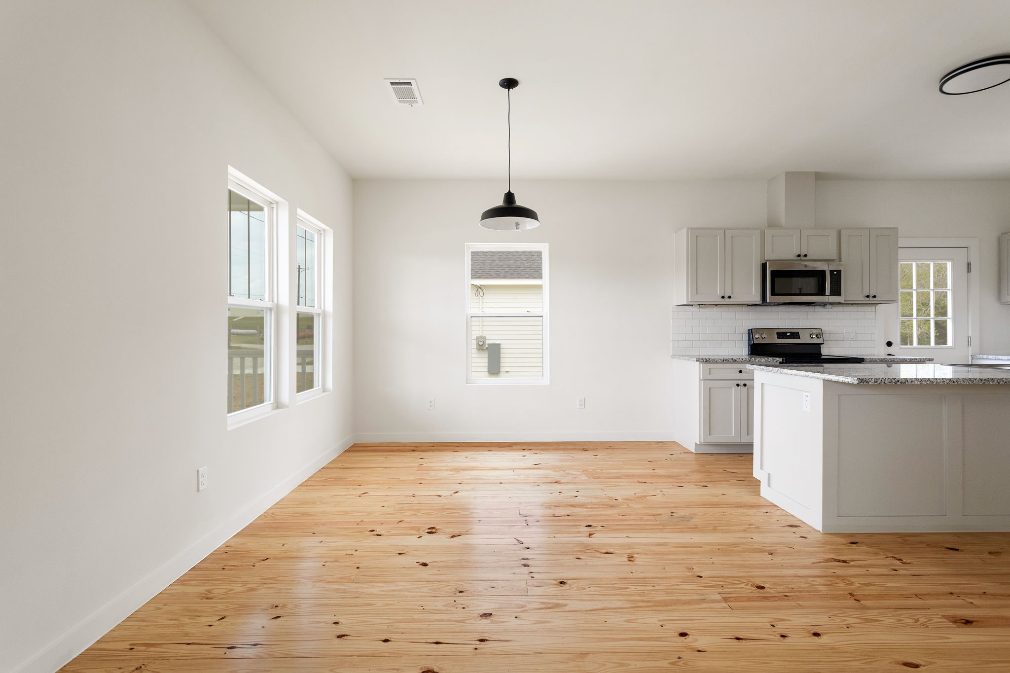 226 North Dixie Street Brenham, TX 77833 - Photo 5 of 22 a kitchen with kitchen island white cabinets and window