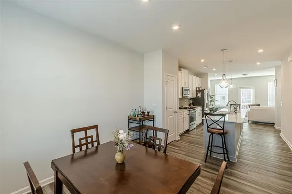 a living room with furniture and kitchen view