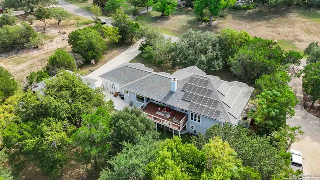 an aerial view of a house with outdoor space and lake view
