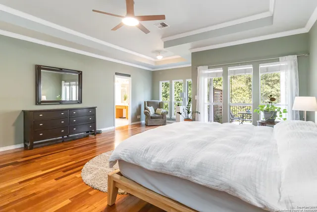 a spacious bedroom with a large bed and a dresser