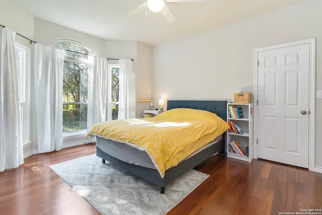 a large bed sitting in a bedroom next to a window