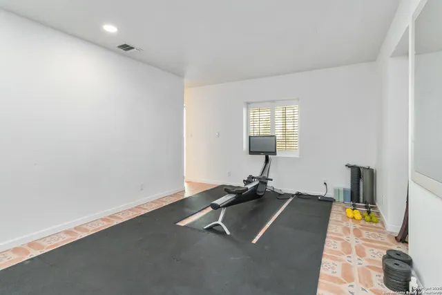 a room with gym equipment and a table