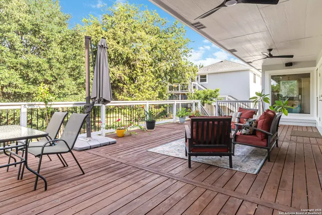 a view of a deck with table and chairs and wooden floor