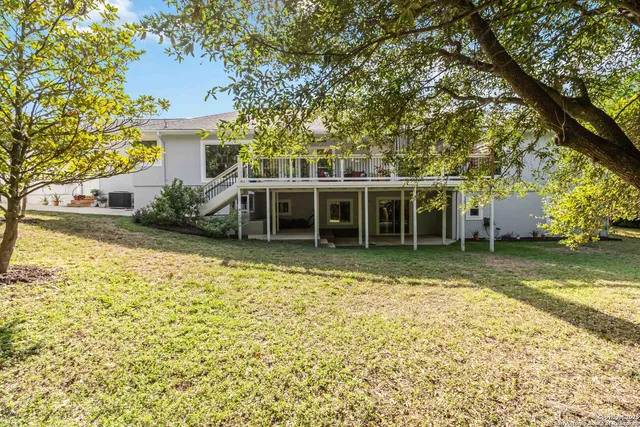 a view of house with outdoor space and swimming pool