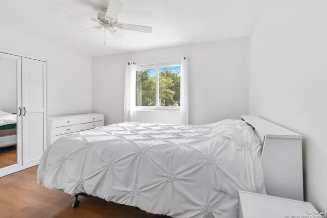 a bedroom with a bed and a window