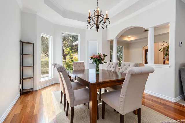 a view of a dining room with furniture and wooden floor