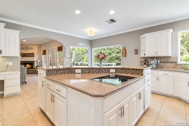 a kitchen that has a sink and a stove in it